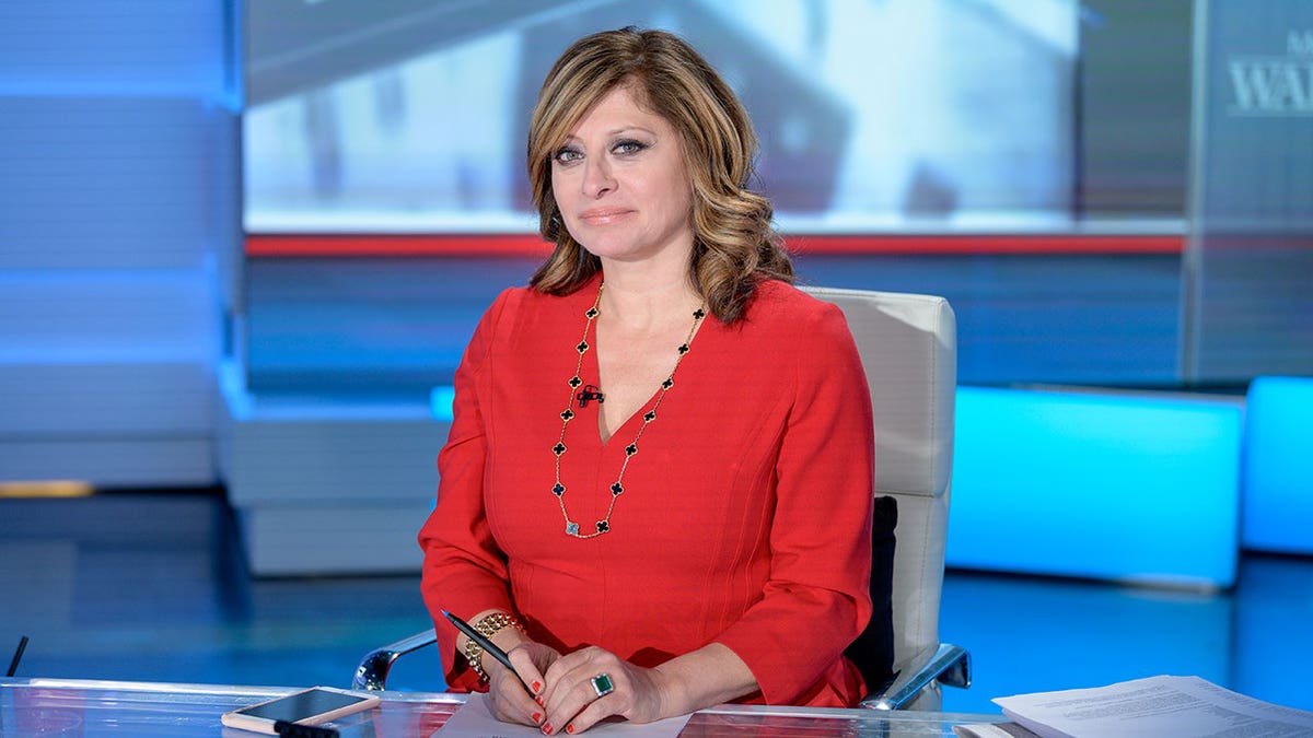 Maria Bartiromo smiles at the camera in a red outfit