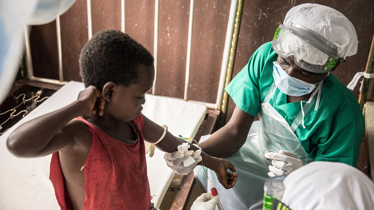 blood sample drawn from boy in africa