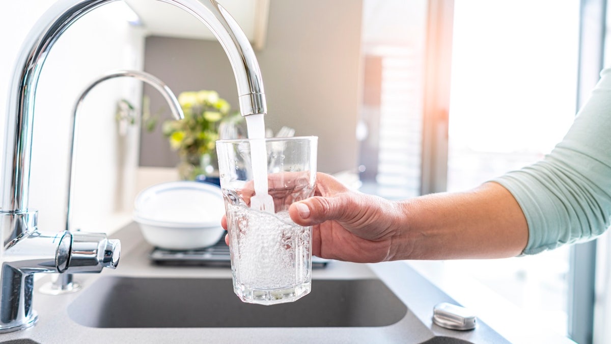 Woman filling tap water