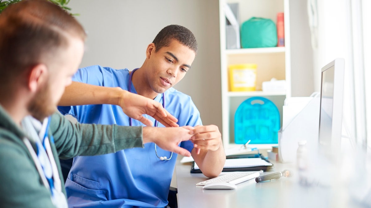 Doctor looking at hand