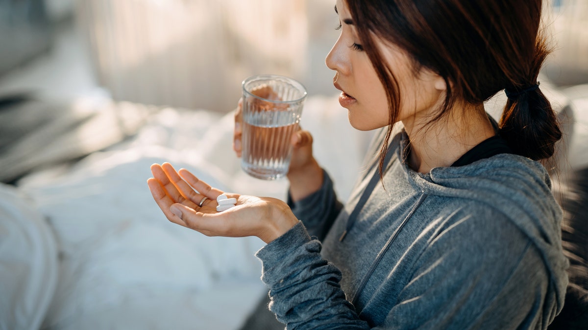 Woman holding pills