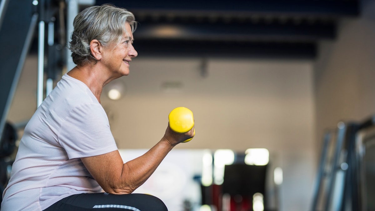 Senior woman lifting weights