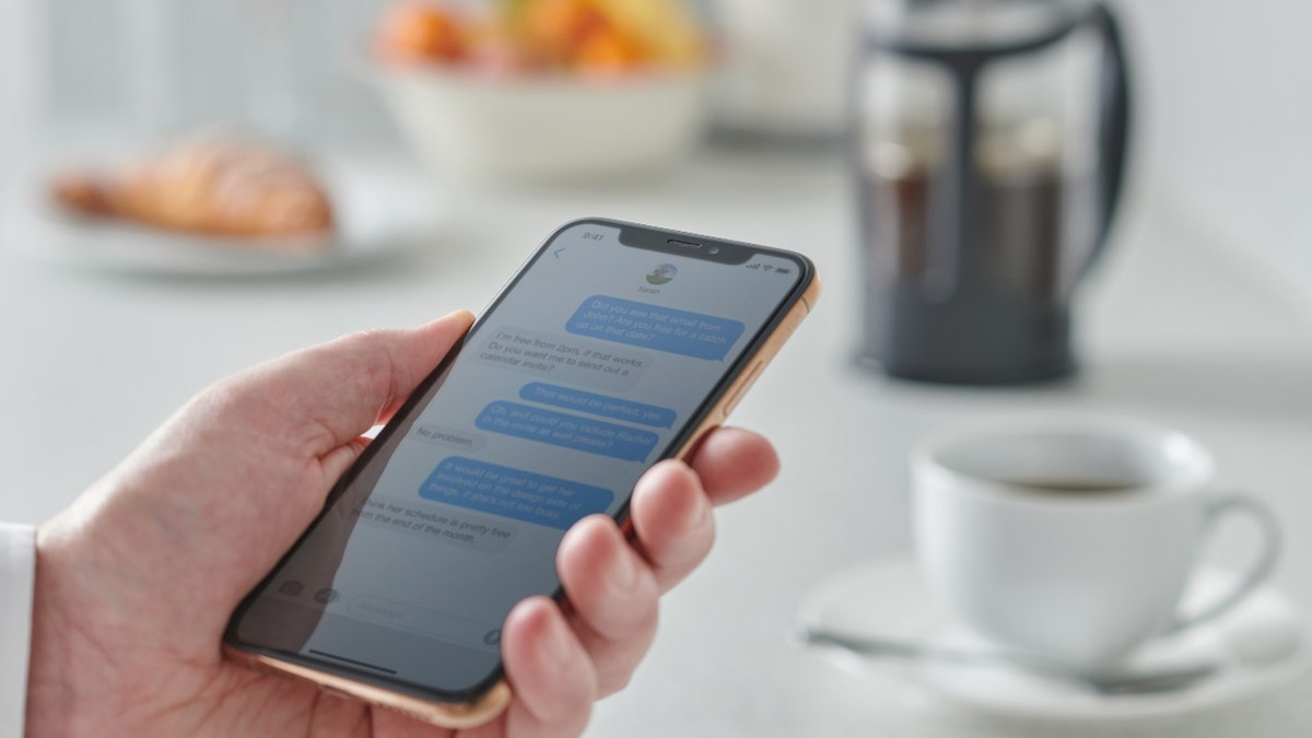 A man holds an iPhone