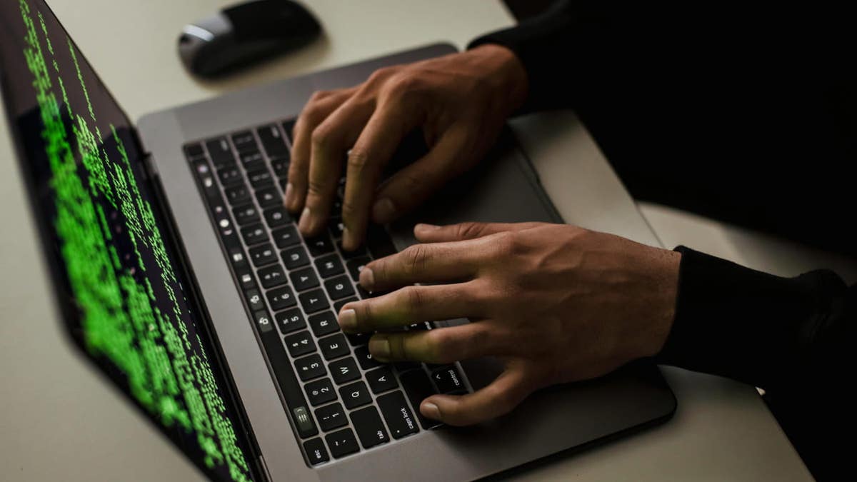 person typing on laptop