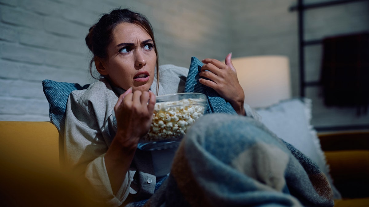 Woman watching a scary movie